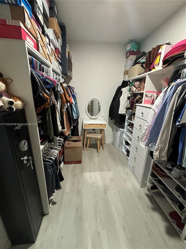 spacious closet featuring light wood-style flooring