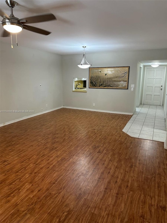 unfurnished room featuring hardwood / wood-style floors and ceiling fan