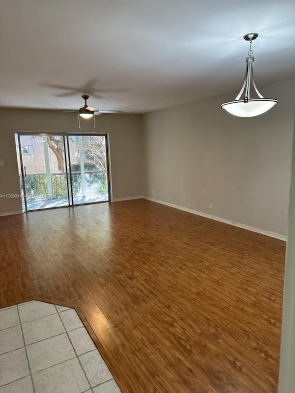 empty room with ceiling fan and hardwood / wood-style flooring