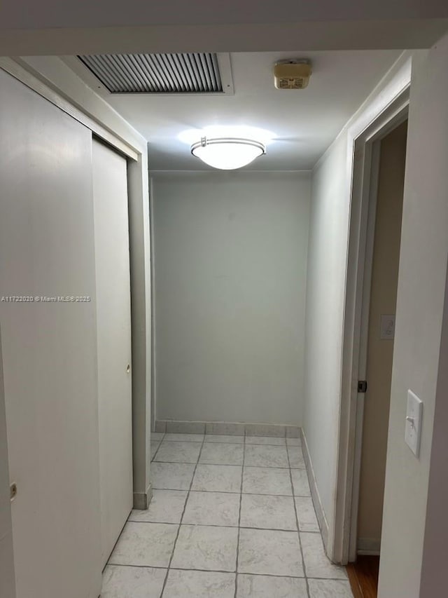 hallway featuring light tile patterned flooring