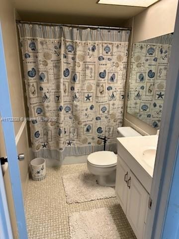 bathroom with tile patterned floors, vanity, and toilet