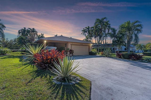 view of front of property featuring a garage and a yard