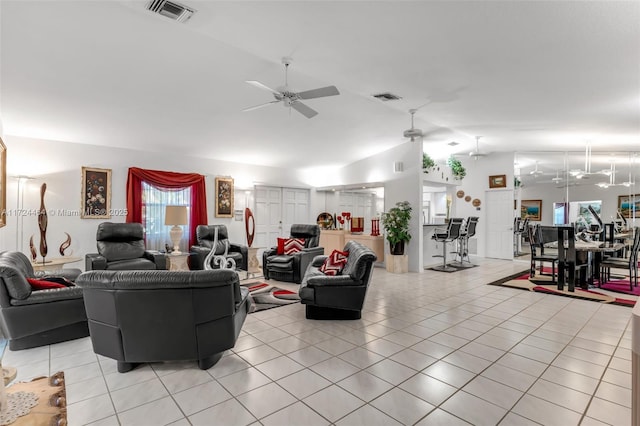 living room with light tile patterned floors, ceiling fan, and lofted ceiling