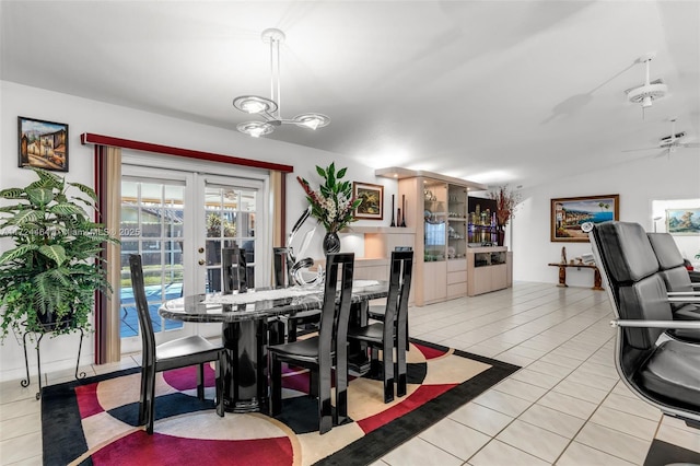 dining space featuring light tile patterned floors, french doors, and ceiling fan