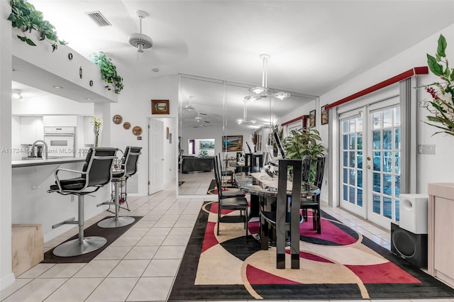 dining area featuring french doors, vaulted ceiling, ceiling fan, sink, and light tile patterned floors