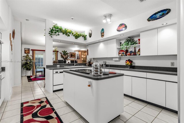 kitchen with white cabinetry, a center island, dishwasher, black gas stovetop, and light tile patterned flooring