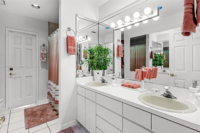 bathroom with tile patterned floors and vanity