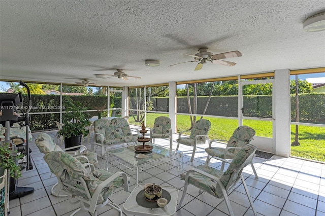 unfurnished sunroom with ceiling fan