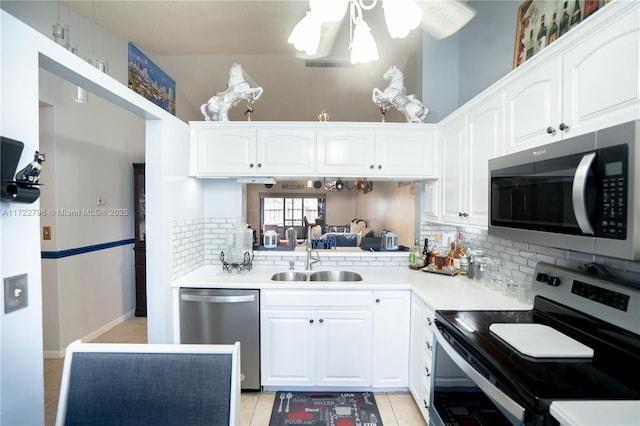 kitchen featuring white cabinets, backsplash, stainless steel appliances, and sink