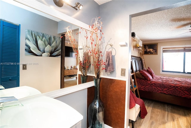 bedroom featuring hardwood / wood-style floors and a textured ceiling