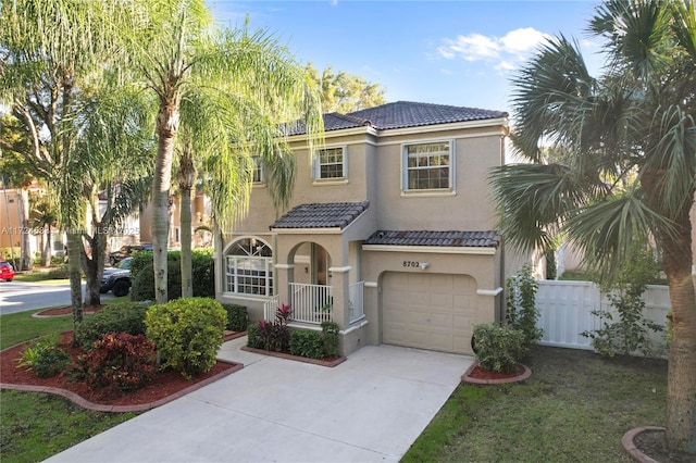 mediterranean / spanish home with a garage and a front lawn