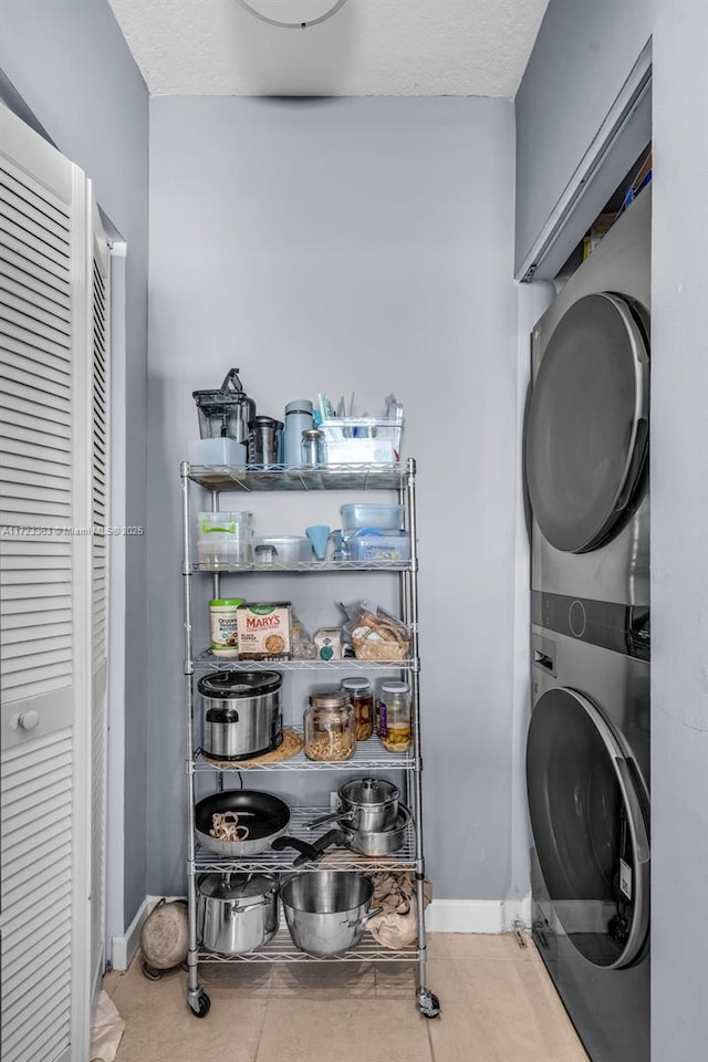 washroom with stacked washer / dryer and a textured ceiling