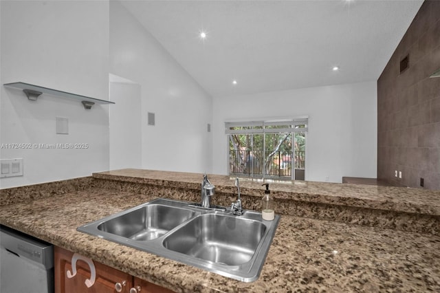 kitchen featuring stainless steel dishwasher, lofted ceiling, and sink