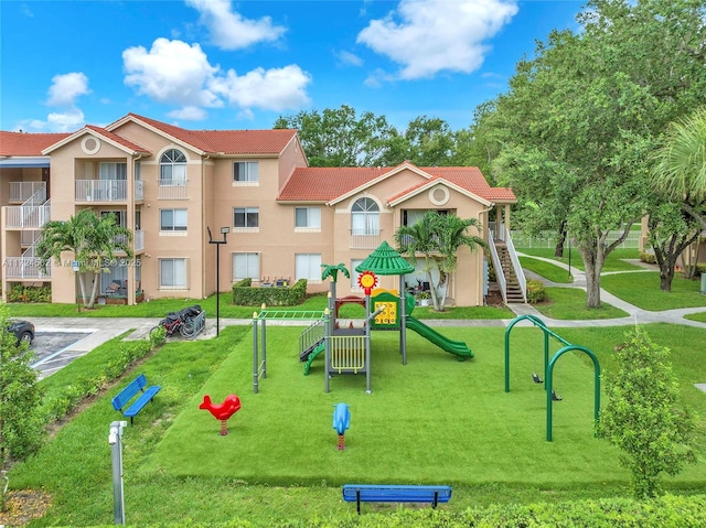 view of community with a playground and a lawn