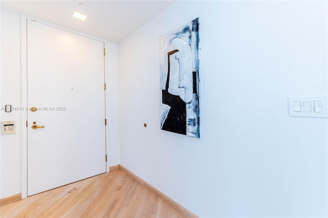 hallway with hardwood / wood-style floors