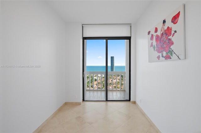 empty room with expansive windows and a water view