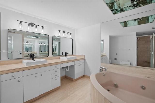 bathroom with plus walk in shower, vanity, and hardwood / wood-style floors