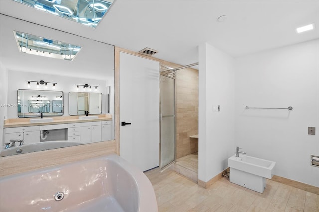 bathroom featuring a bidet, an enclosed shower, vanity, and hardwood / wood-style flooring