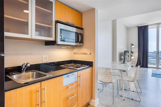 kitchen with sink, light tile patterned floors, and white gas cooktop