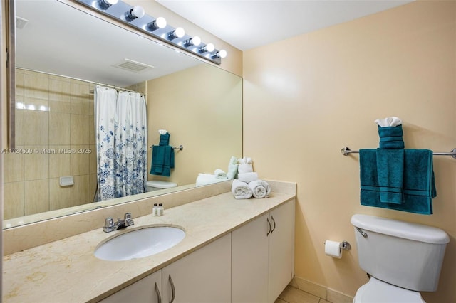 bathroom with vanity, a shower with curtain, tile patterned floors, and toilet