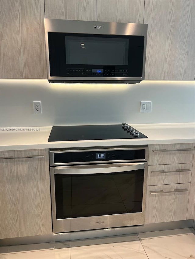 kitchen with light brown cabinets and stainless steel appliances