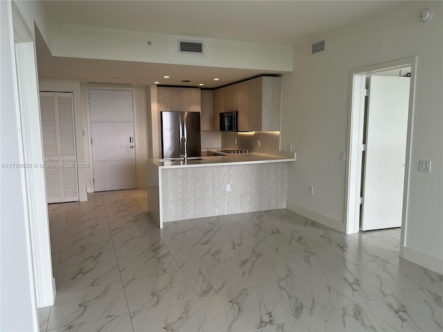 kitchen with kitchen peninsula, stainless steel fridge, and white refrigerator