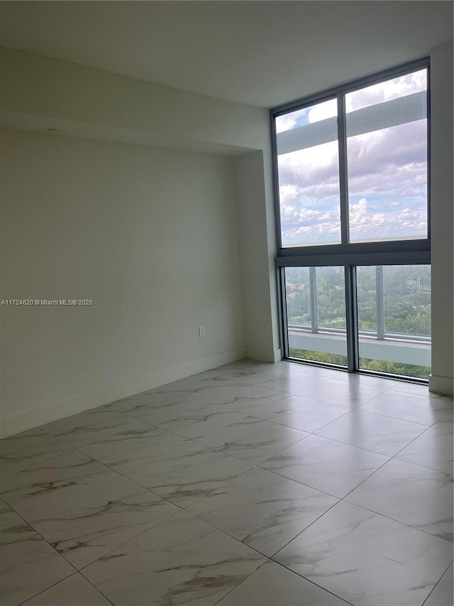 empty room with a wealth of natural light and a wall of windows