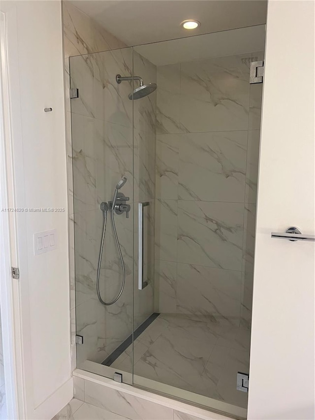 bathroom featuring a shower with door