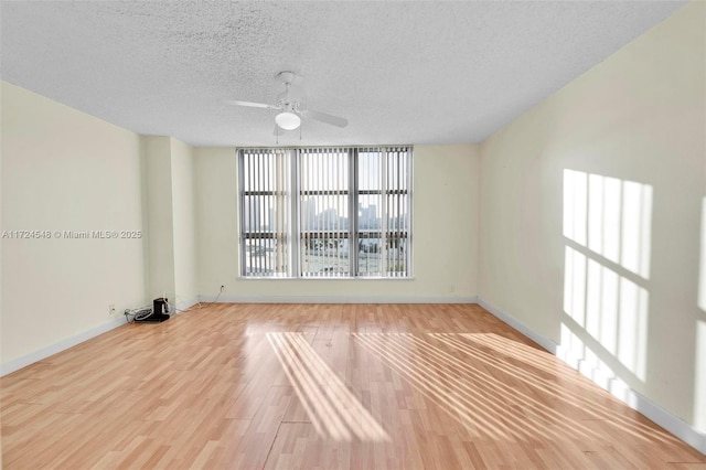 spare room featuring ceiling fan, a textured ceiling, and light hardwood / wood-style floors