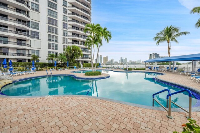 3530 Mystic Pointe Dr Unit 710, Aventura, FL 33180 - community pool featuring a city view, a patio area, and fence