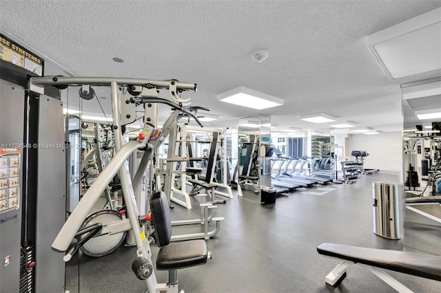 exercise room with a textured ceiling