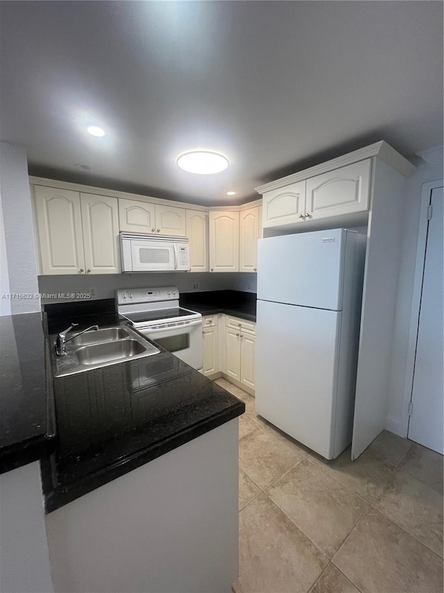 kitchen with white cabinetry, sink, and white appliances