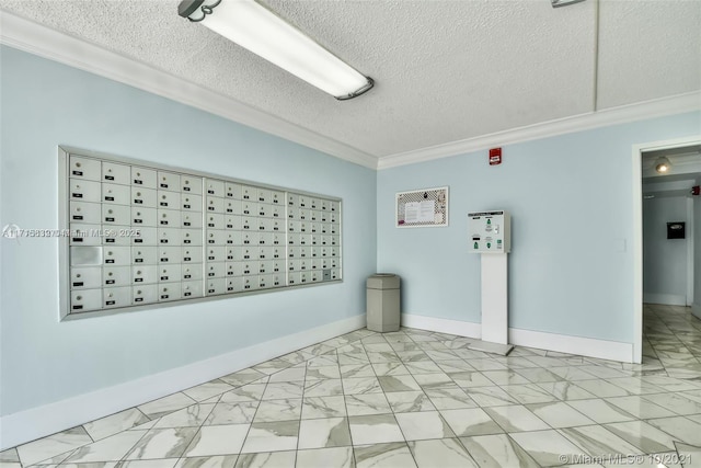 empty room featuring a textured ceiling, mail boxes, and crown molding