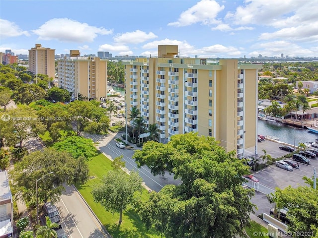 view of property featuring a city view, a water view, and uncovered parking