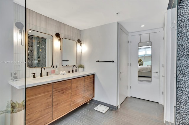 bathroom with tasteful backsplash and vanity