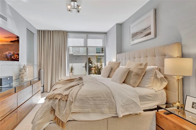 bedroom with an inviting chandelier and access to outside