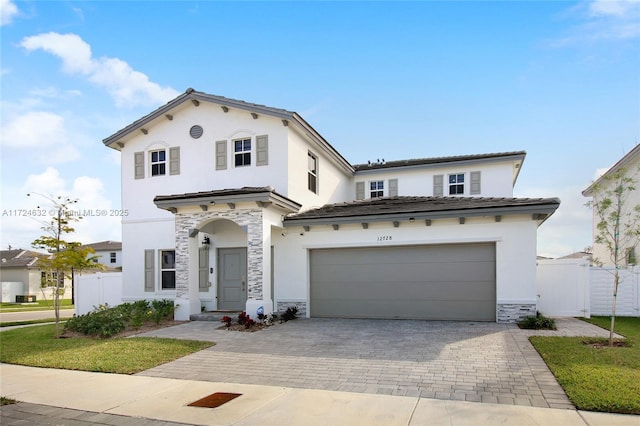 mediterranean / spanish-style house with a garage