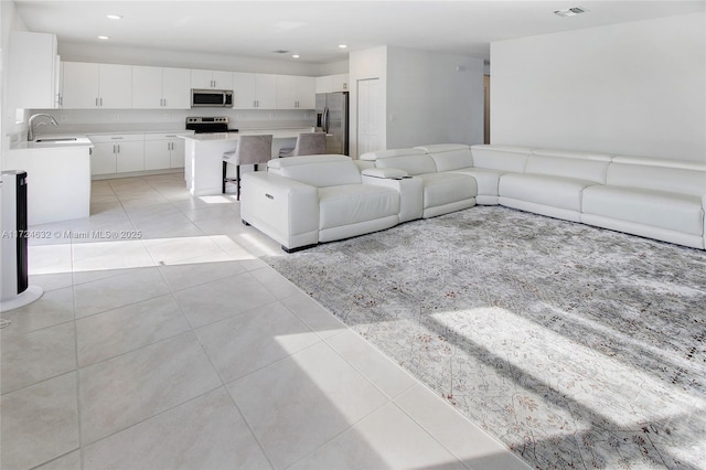 tiled living room featuring sink