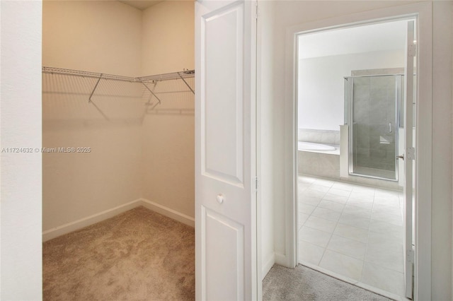 walk in closet featuring carpet floors