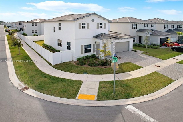 mediterranean / spanish-style house featuring a garage and a front yard