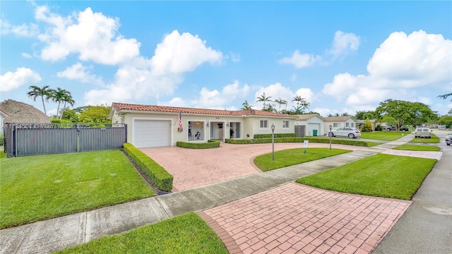 mediterranean / spanish house with a garage and a front lawn