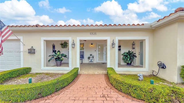 view of exterior entry with a garage