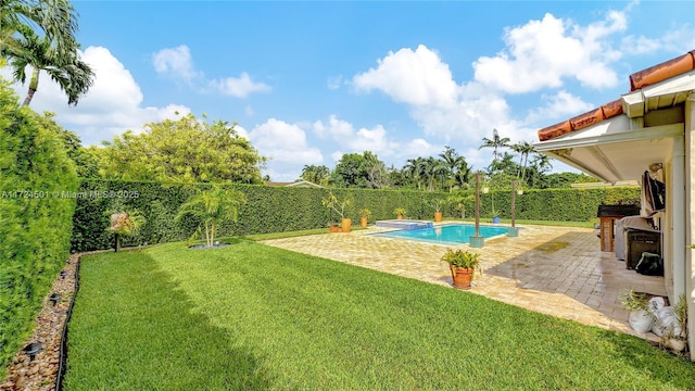 view of swimming pool with a yard and a patio