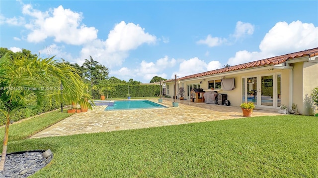 view of swimming pool with a lawn and a patio area