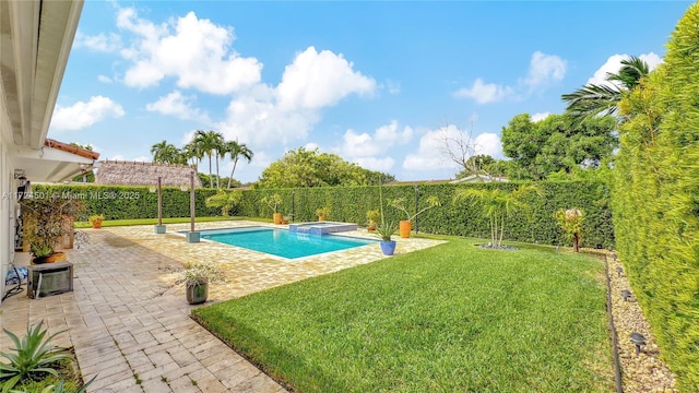 view of pool featuring a patio area, an in ground hot tub, and a yard