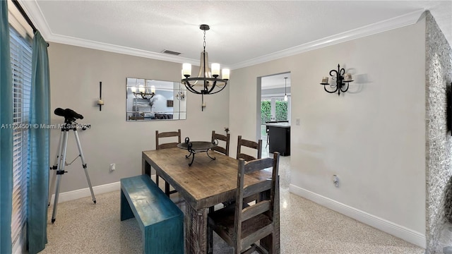 dining space with ornamental molding, a textured ceiling, and a notable chandelier