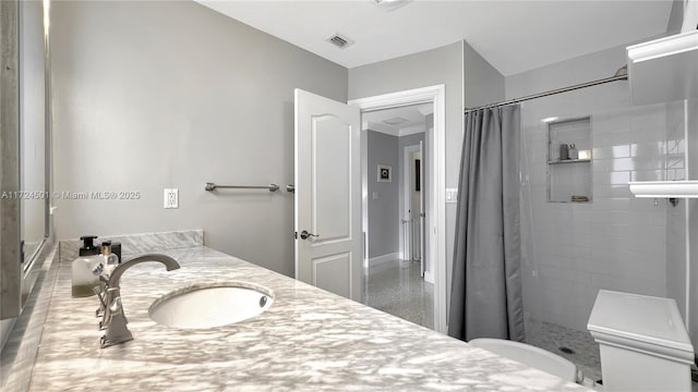 bathroom featuring vanity, toilet, and curtained shower