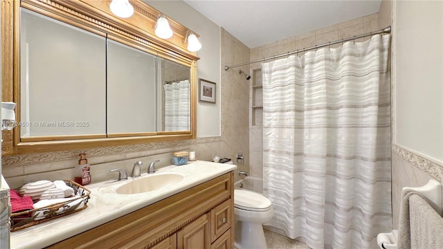 full bathroom with shower / bathtub combination with curtain, vanity, tile walls, and toilet