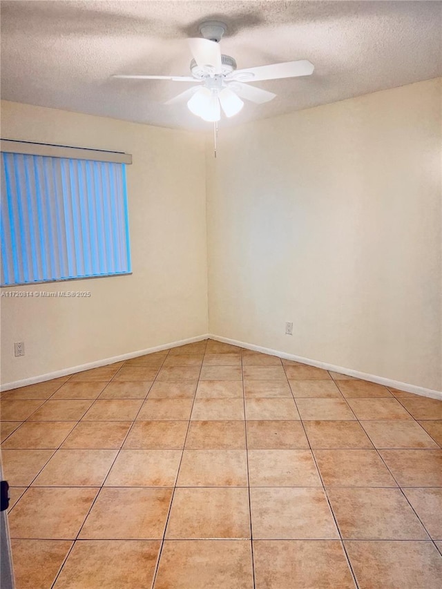 1024 Coral Club Dr Unit 1024, Coral Springs, FL 33071 - spare room with light tile patterned flooring, baseboards, ceiling fan, and a textured ceiling
