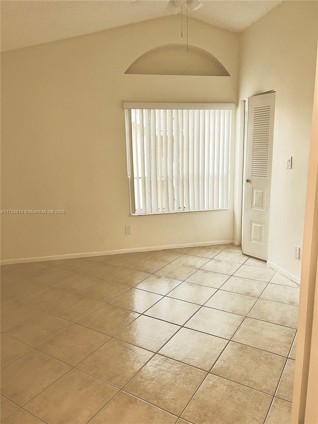 1024 Coral Club Dr Unit 1024, Coral Springs, FL 33071 - unfurnished room featuring vaulted ceiling, light tile patterned floors, baseboards, a textured ceiling, and ceiling fan